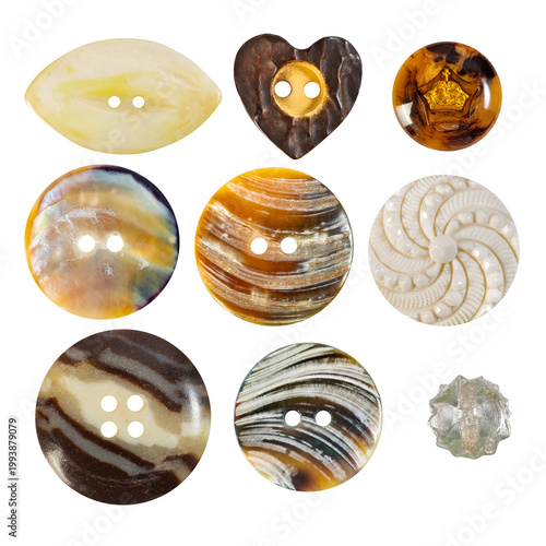 Isolated photo of various colored nacre cloth buttons on white backdrop.
