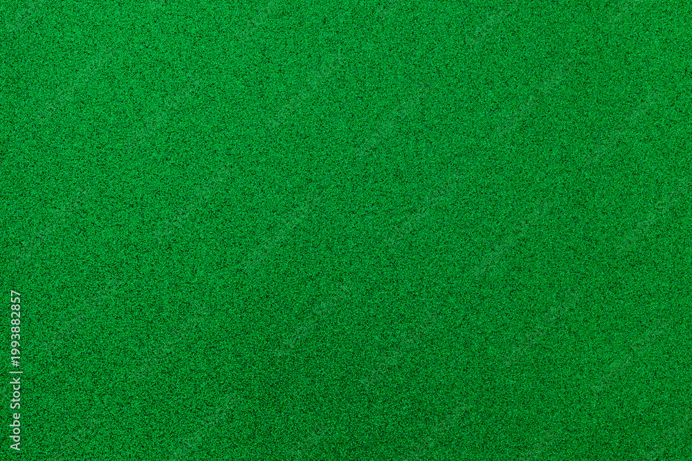 Fototapeta premium Surface covered in green material used for various activities and settings in a well-lit indoor environment during the daytime