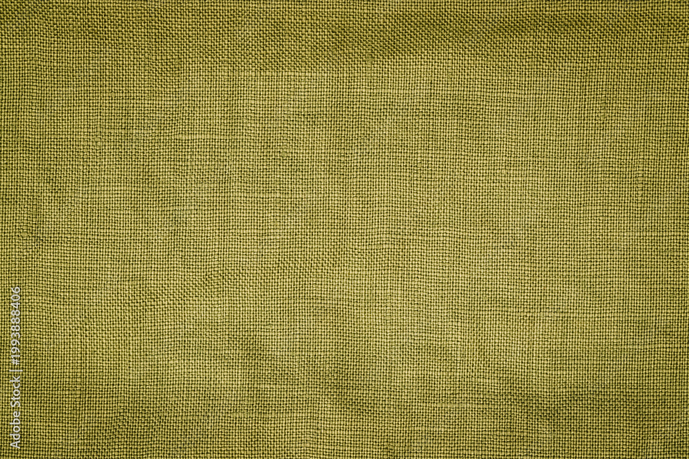 Fototapeta premium Texture of green fabric laid out on a flat surface for background or design use mid-afternoon in a well-lit indoor setting