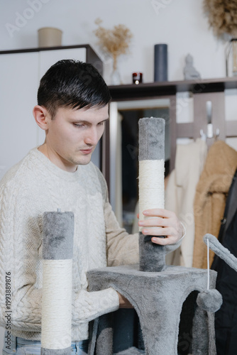 One person is assembling a new cathouse at home.