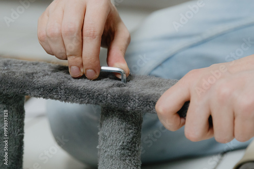 One person is assembling a new cat house at home.