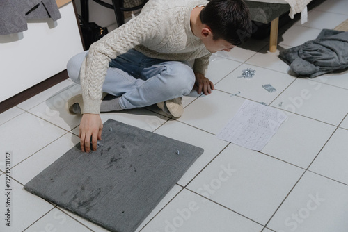 One person is assembling a new cat house at home.