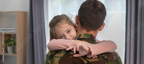 Obraz na plátne Emotional soldier father and daughter family hug during military homecoming