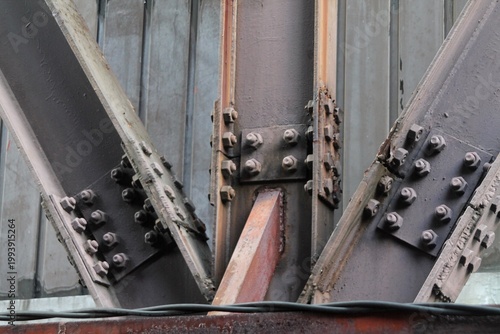 Φωτογραφία Industrial Steel Bridge Structure With Bolted Joints, Rusted Beams And Metal Tru