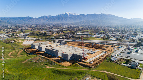 aerial of village next to mountain snow capped