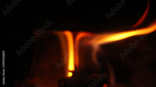 фотографія Close up of burning wood logs blazing in flames inside black wrought iron wood burning fire