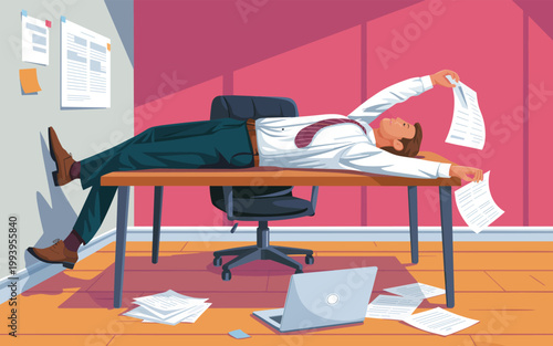 Businessman falls asleep at office desk with papers and laptop nearby on floor