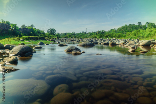 Beautiful morning view in Indonesia, panoramic landscape of rice fields with mountain ranges and clear sky