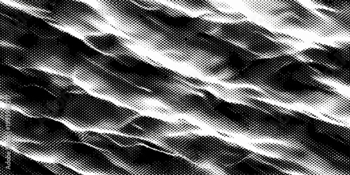 Luxurious black and white silk fabric texture featuring smooth rippled waves and elegant satin material for a soft fashion backdrop