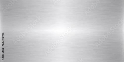 Industrial brushed metal texture background featuring a shiny silver stainless steel plate surface with a grey metallic pattern and reflective aluminum alloy sheet backdrop