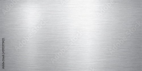 Industrial grey brushed metal texture background featuring a shiny stainless steel surface with a metallic silver aluminum pattern on a seamless material sheet backdrop