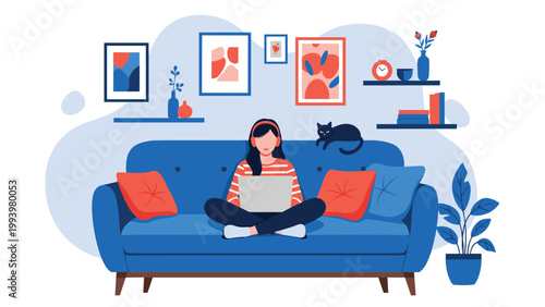 Young woman sitting cross-legged on a sofa and working on her laptop while her black cat rests nearby in a cozy decorated interior.