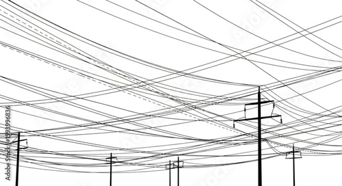 Overhead power lines crisscrossing against a bright sky.