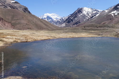 Aconcagua peak towering above high altitude lake