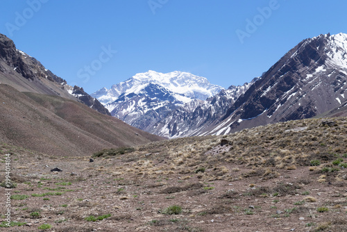 Aconcagua peak towering over dry andes valley in mendoza