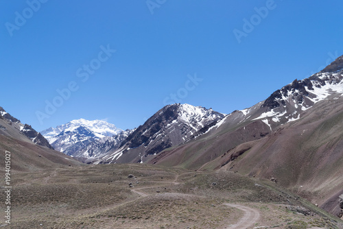 Aconcagua peak towering over dry valley andes mountains