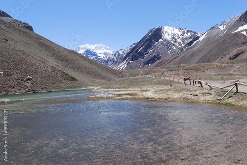 Andes mountains landscape with aconcagua summit and clear lake