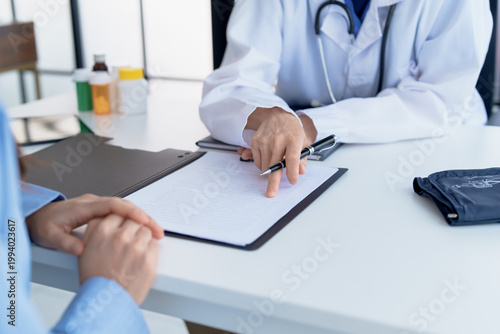 Canvastavla Doctor explaining treatment plan and obtaining informed consent while patient signing consent form in hospital