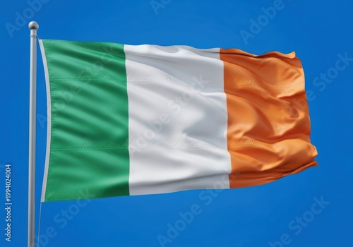 Flag of ireland waving in the wind against a clear blue sky background