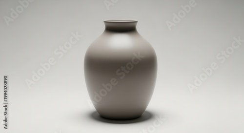 Elegant grey vase standing alone. Soft light emphasizes the simple shape in a minimalist modern style against a plain background. Home decor focus.
