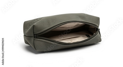 Olive green toiletry bag lies open on white surface in studio shot. Cosmetics are inside. Simple, essentialist, clean and minimalist, design.