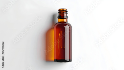 Amber glass bottle on white surface studio shot with minimalist design and clean aesthetic suitable for cosmetic product mockups