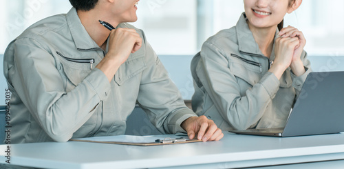 Принти на полотні Male and female staff in work clothes lined up at desks for interviews, meetings, and discussions