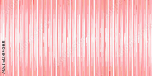 Abstract background of vertically aligned translucent pink plastic straws