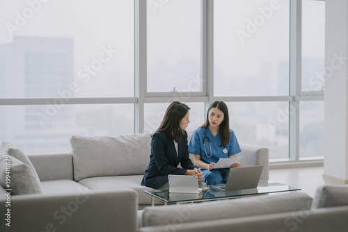 young woman sitting on sofa with laptop