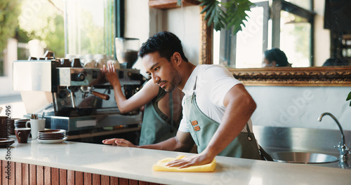 Photos Cleaning, cloth and counter with man in coffee shop for maintenance of small business startup