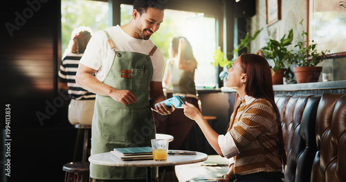 Картината върху платно Happy people, customer and waiter with pos machine in coffee shop for credit card payment