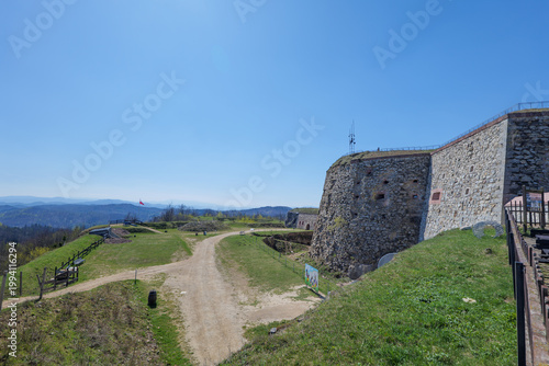Srebrna Góra Fortress. April 2026. Explore the historic stone fortress on a sunny day overlooking the green hills and path with clear blue skies