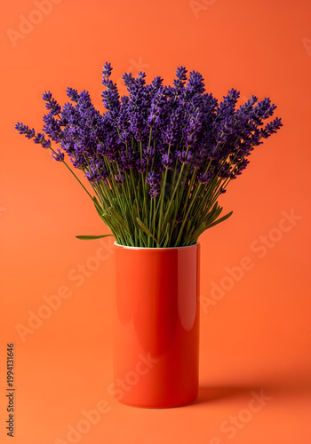 A bouquet of lavender in a bright orange ceramic vase against an orange background; a minimalist floral still life featuring vibrant colors, soft shadows, and space for text. AI generated.

