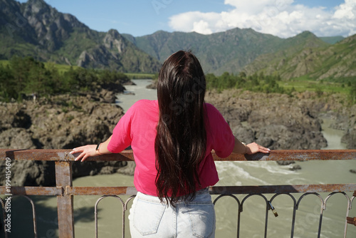 enjoying the mountain nature while standing by the river