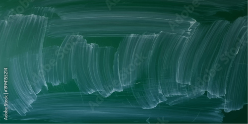 A cold cascade of liquid icicles hangs against a deep blue nature landscape where frozen water drops fall over stone rocks like a silent flowing stream