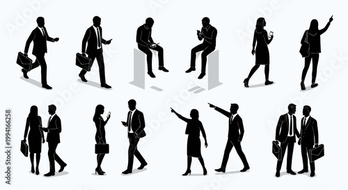 silhouetted business people interacting and using mobile devices
