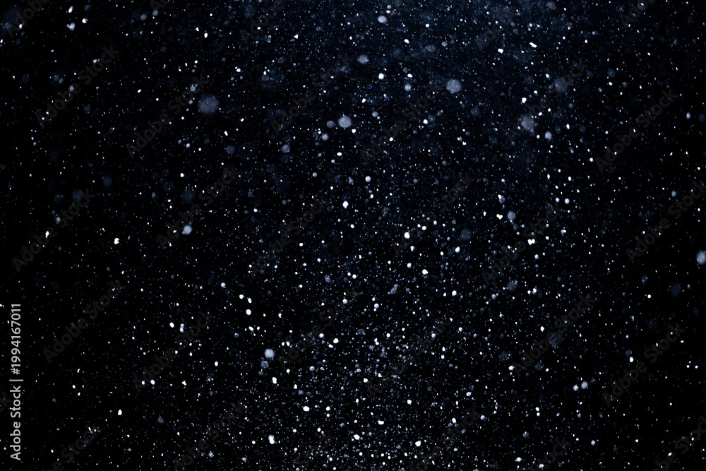 Fototapeta premium Snowflakes confetti for Christmas design. Falling snow particles on transparent background. Snow overlay effect with winter ambiance. White snowfall layer drifting in wind. Realistic snow particles.