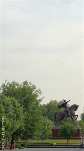 Amir Timur equestrian statue in Tashkent park with Uzbekistan flag