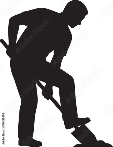 A silhouette of a man actively shoveling debris on a construction site outdoors.