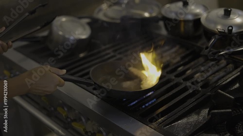 Grilling Beef Steak On A Hot Pan With Flashing Flames, A video of beef steak searing on a hot pan, capturing bold smoky intensity, perfect for food documentary and culinary film.