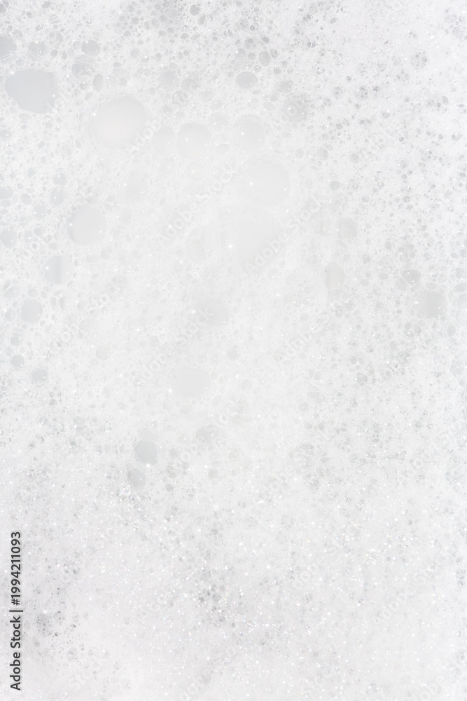 Fototapeta premium Bubbling foam creating an opaque surface in a serene setting during the daytime