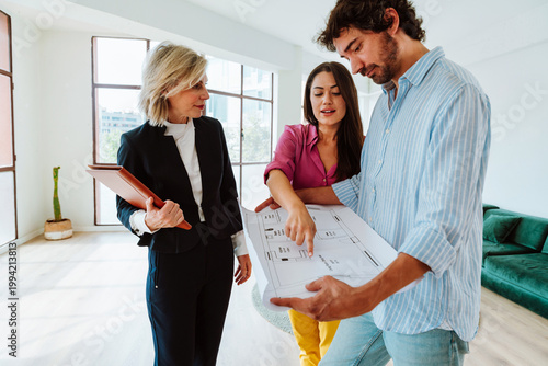 Real estate agent showing an apartment to a couple.