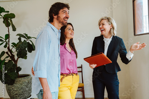 Real estate agent showing an apartment to a couple.