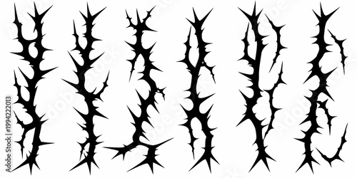 A collection of sharp black thorn like shapes against a white background