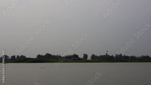 Riverside House Atmosphere At Evening By Chao Phraya River, A film of house by river at dusk, golden light on calm water and city glow, perfect for tranquil lifestyle film or escape documentary.