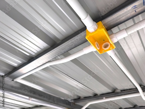 PVC pipe and junction box routing for electrical system and structure.