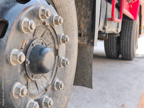 Details regarding the condition of the wheel nuts and tires of a heavy-duty truck.