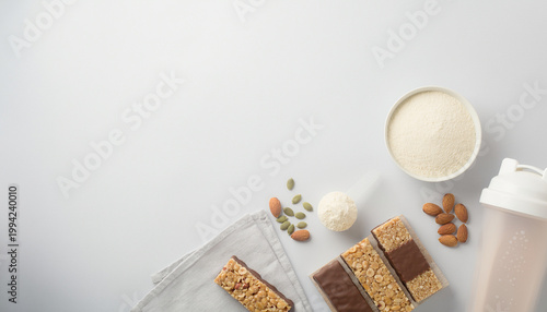 A selection of protein bars, nuts, and supplements on a table