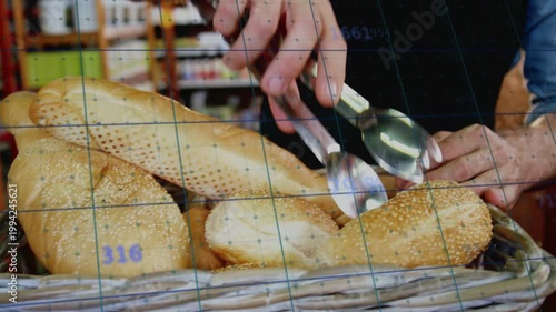 Baker using tongs in bakery, probing, clamping, lifting seeded roll, selecting while grid showing %