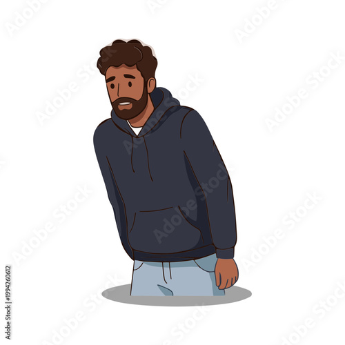 A man wearing a dark blue hoodie and jeans looks down